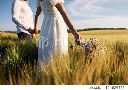Beautiful sunlight. Couple just married. Together on the majestic agricultural field 124626533
