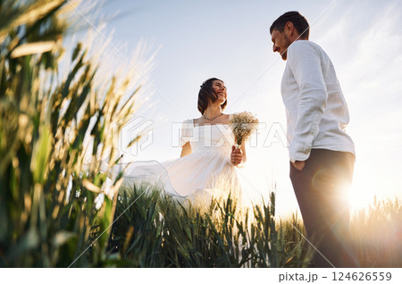 Happy people. Couple just married. Together on the majestic agricultural field at sunny day 124626559