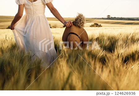 Beautiful young bride in white dress is on the agricultural field at sunny day 124626936