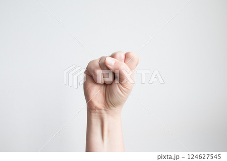 Caucasian female hand fist gesture against white background 124627545