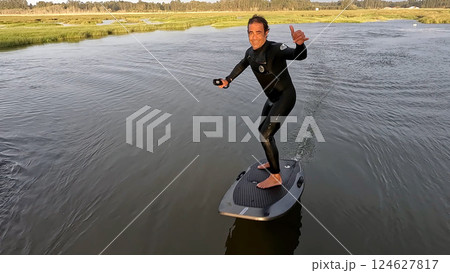 Hydrofoil rider gliding over the water 124627817