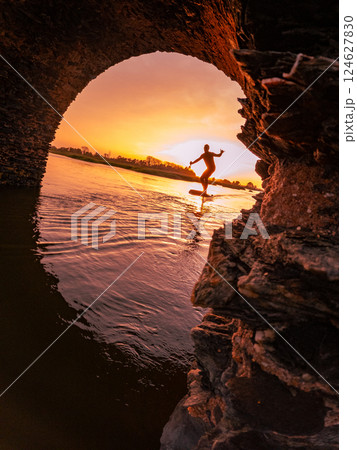 Hydrofoil rider gliding over the water 124627830