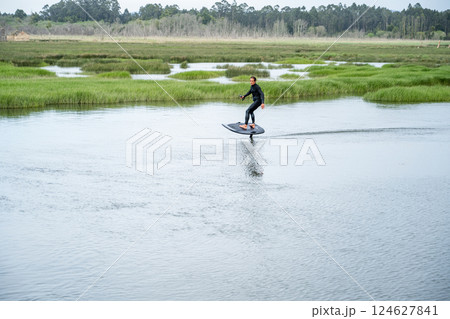 Hydrofoil rider gliding over the water 124627841