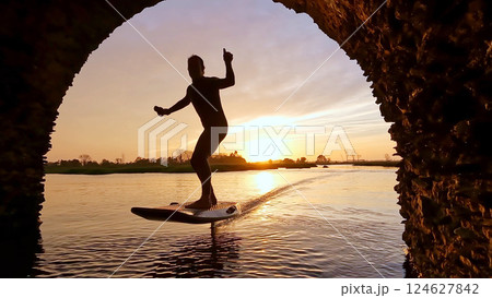 Hydrofoil rider gliding over the water 124627842