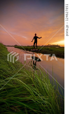 Hydrofoil rider gliding over the water 124627851