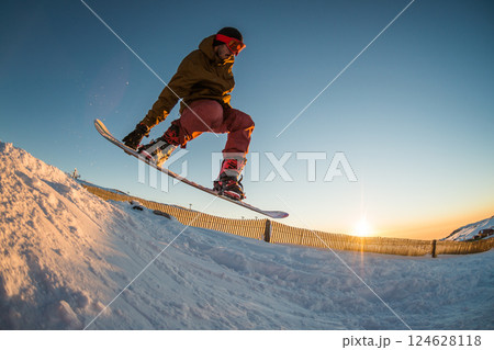 Snowboarding in the mountains Snowboarding in the mountains 124628118