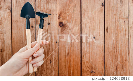 Small garden tools on wooden planks background 124628918