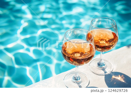 Relaxing afternoon by the pool with chilled glasses of cognac under the sun 124629726