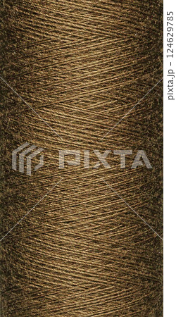 macro texture of a skein of brown sewing thread macro texture of a skein of brown sewing thread 124629785