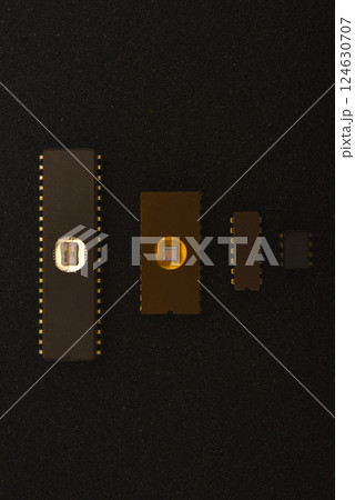 Several microchips on black foam. Old integrated circuits for radio electronics. Several microchips on black foam. Old integrated circuits for radio electronics. 124630707
