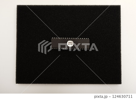 The microcircuit is on black foam. An integrated circuit for radio electronics. 124630711