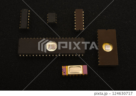 Several microchips on black foam. Old integrated circuits for radio electronics. 124630717