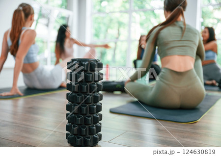 Resting on the mats. Group of women practicing fitness in the gym Resting on the mats. Group of women practicing fitness in the gym 124630819