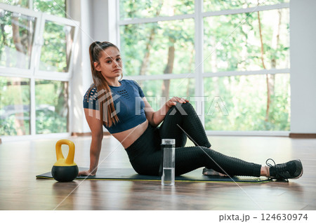 With weight for lifting. Woman in sportive clothes is having fitness day in the gym 124630974