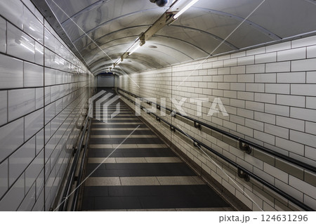 Empty Tunnel in the London Underground with White Tiles and Fluorescent Lights 124631296