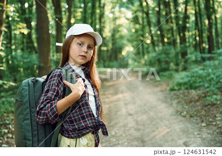 Portrait of girl that is in the forest at summer day time discovering new places Portrait of girl that is in the forest at summer day time discovering new places 124631542
