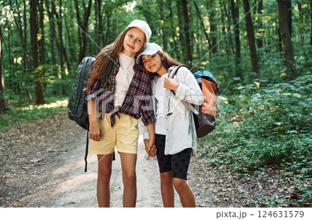 Front view. Two girls is in the forest having a leisure activity, discovering new places 124631579