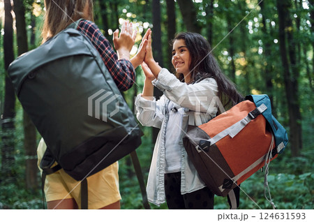 Smiling and having fun. Two girls is in the forest having a leisure activity, discovering new places 124631593