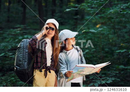 Front view of two girls that is in the forest having a leisure activity 124631610