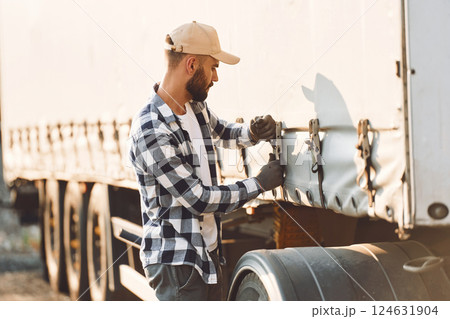 Ready for the ride. Young truck driver is with his vehicle at daytime 124631904