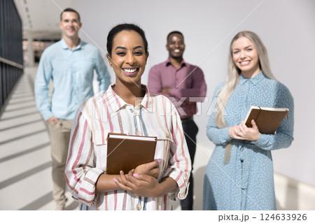 Team posing for camera led by confident African female leader Team posing for camera led by confident African female leader 124633926