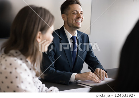 Laughing businessman in suit take part in briefing with teammates 124633927