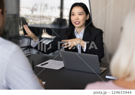 Young Asian businesslady conduct meeting with shareholders Young Asian businesslady conduct meeting with shareholders 124633944