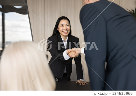 Asian applicant shaking hand HR manager finish successfully job interview Asian applicant shaking hand HR manager finish successfully job interview 124633969