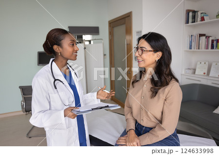Happy young Black doctor telling good news to older patient Happy young Black doctor telling good news to older patient 124633998