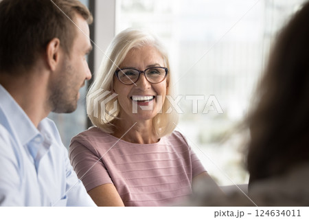 Close up mature businesswoman laughing, take part in formal meeting 124634011