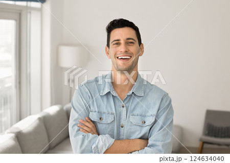 Hispanic man standing in contemporary living room Hispanic man standing in contemporary living room 124634040