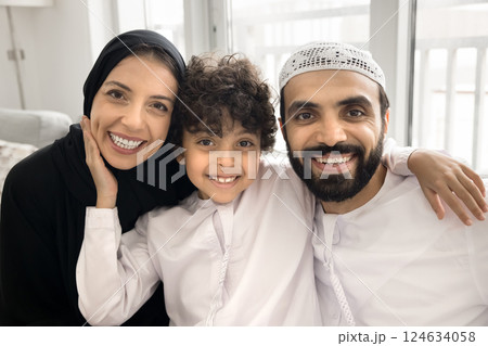 Beautiful young Arabic family with little son posing for camera Beautiful young Arabic family with little son posing for camera 124634058