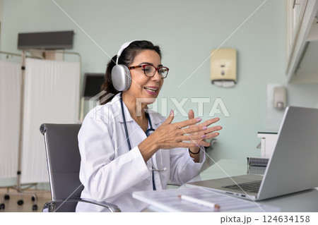 Happy senior doctor using telemedicine technology for online consultation 124634158