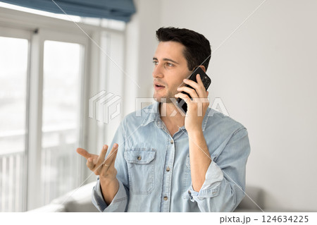 Handsome Hispanic man engaged in phone conversation 124634225