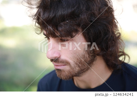 Sad Long Hair Man Is About To Cry From Depression In The Nature Park Sad Long Hair Man Is About To Cry From Depression In The Nature Park 124634241