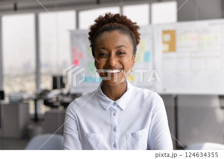 Happy successful beautiful African American businesswoman posing for head shot 124634355