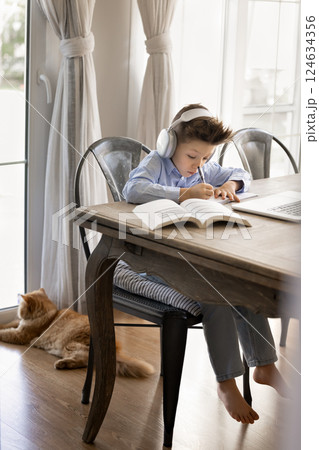 Boy e-learns subject, homeschooling, engaged in remote education 124634356