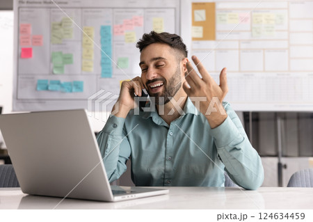 Positive young Hispanic manager man enjoying work communication Positive young Hispanic manager man enjoying work communication 124634459