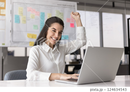 Cheerful excited successful Hispanic manager woman enjoying business success 124634543