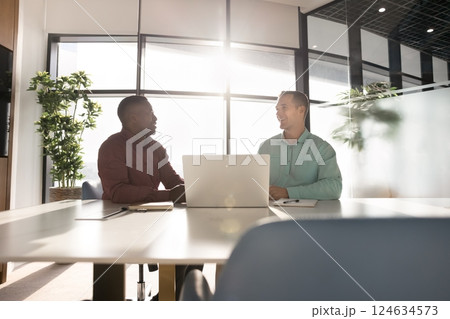 Successful businessmen lead talk sit at conference desk with laptop 124634573