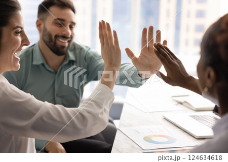 Diverse team of happy excited colleagues giving group high five Diverse team of happy excited colleagues giving group high five 124634618