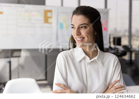 Happy confident successful young Latin manager standing with hands folded 124634662