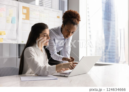 Young Latin project manager woman consulting female African business leader Young Latin project manager woman consulting female African business leader 124634666