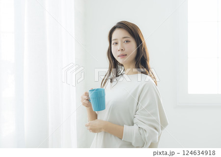 部屋でコーヒーを飲む女性 部屋でコーヒーを飲む女性 124634918