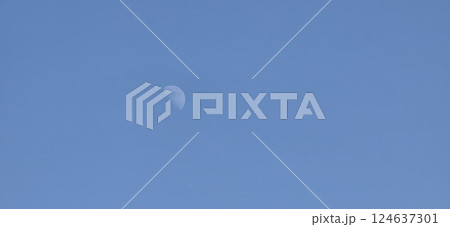 A clear blue sky featuring a crescent moon. Ideal for astronomy, nature themes, or artistic uses in educational content, digital designs, and decor. 124637301