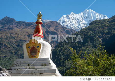 View of Tibetan Buddhist stupa with Mt.Thamserku (6,723m) in the background. Thamserku is a prominent mountain to the east of Namche Bazaar, Nepal. View of Tibetan Buddhist stupa with Mt.Thamserku (6,723m) in the background. Thamserku is a prominent mountain to the east of Namche Bazaar, Nepal. 124637521