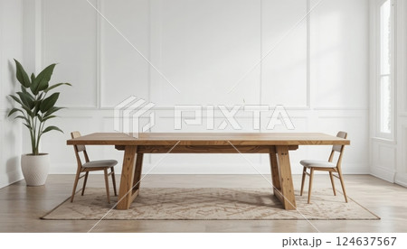 A minimalistic dining space featuring a wooden table, two chairs, and a plant, offering a fresh and inviting atmosphere for family gatherings or meals. 124637567