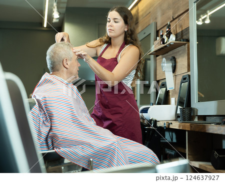 Master barber does the hairstyle and styling. Concept barbershop Master barber does the hairstyle and styling. Concept barbershop 124637927