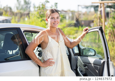 Portrait of smiling girl about to get into her car Portrait of smiling girl about to get into her car 124637972
