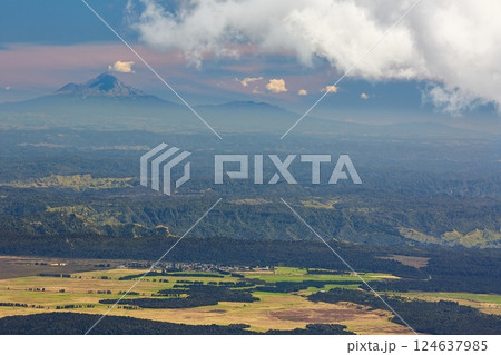 Sunset Hilly Landscape, volcano in the distant background Sunset Hilly Landscape, volcano in the distant background 124637985